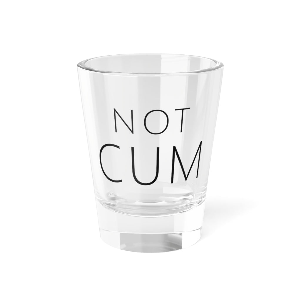 Shot glass reading NOT CUM in thin wide-tracked capitals, front view